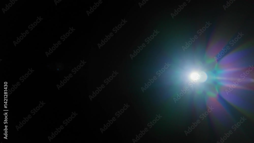 Movement of a beautiful abstract defocused flare on a dark background. Real light leaks and glare. Movement of a beautiful abstract defocused flare on a dark background. Real light leaks and glare.
