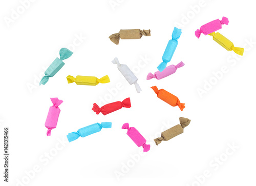 Tasty candies in colorful paper wrappers falling on white background with clipping path.