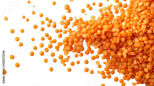 A close-up view of orange lentils spilling downward against a dynamic abstract background.