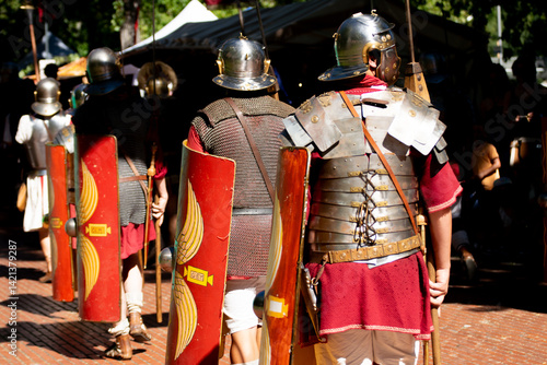 detail of roman armor and scutum shields from behind, roman army reenactment event