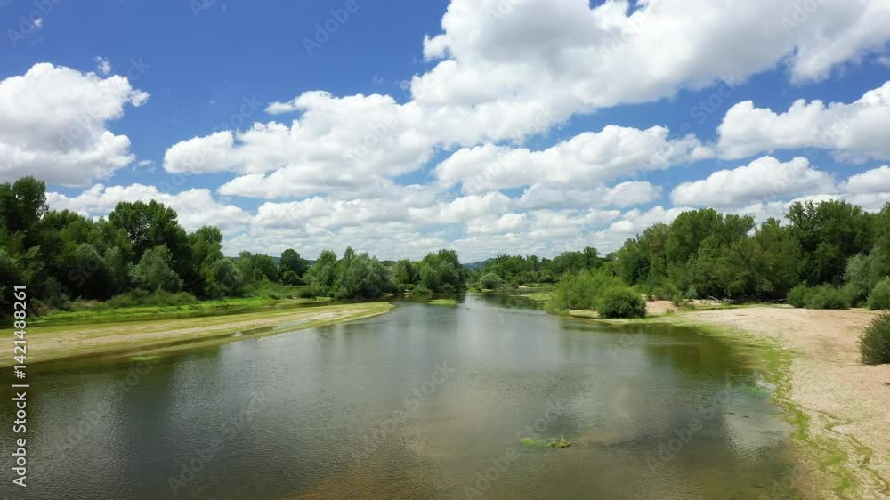 The Loire River in the heart of a green rural landscape in Europe, France, Burgundy, Nievre, Pouilly sur Loire, near Nevers, in summer, on a sunny day. The Loire River in the heart of a green rural landscape in Europe, France, Burgundy, Nievre, Pouilly sur Loire, near Nevers, in summer, on a sunny day.