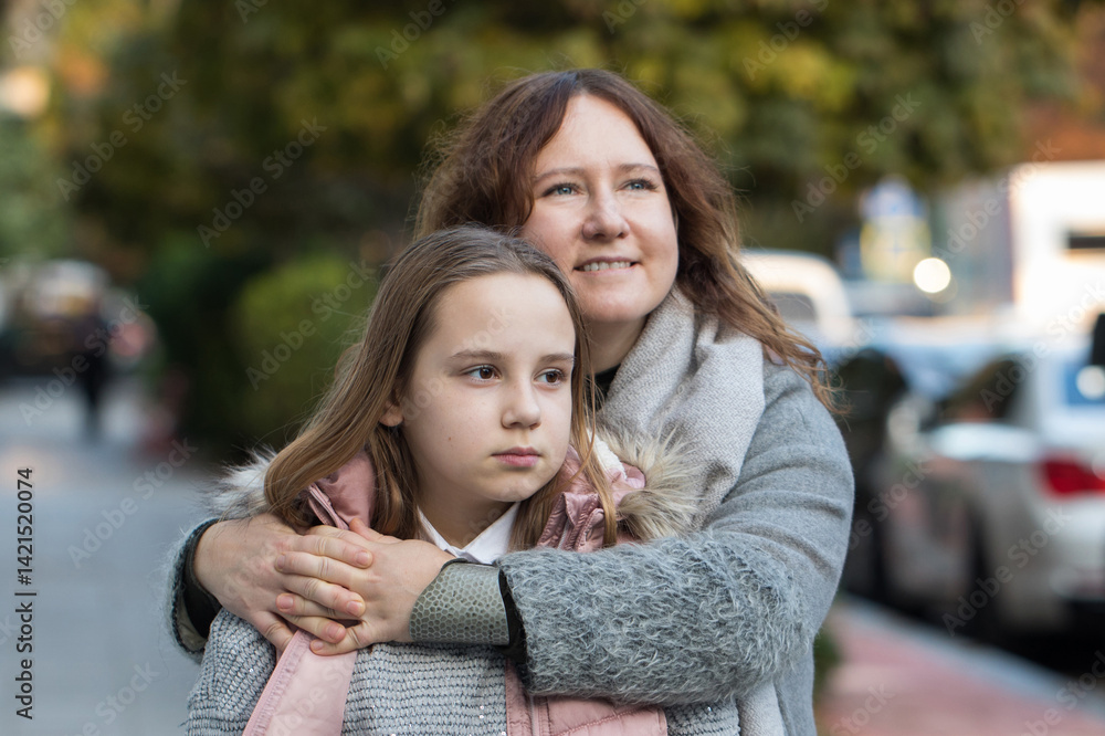 Fototapeta premium Happy woman hugging child. Mother and daughter together. Childhood, happiness, love and family concept