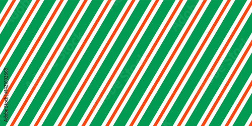 Christmas seamless pattern. Red and green diagonal stripes background. Candy cane repeating decoration wallpaper. Winter holiday lines backdrop. vector