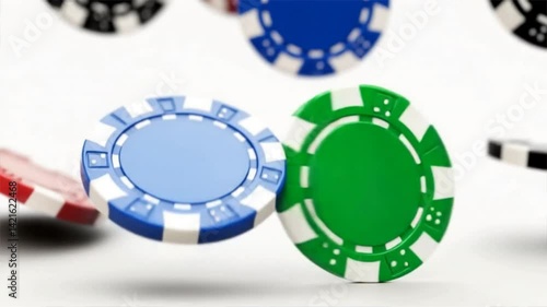 Colorful casino poker chips falling in the air, representing games of chance and excitement in gambling.