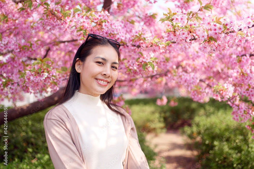 Asian woman enjoying with cherry blossom or sakura blooming during spring in Japan Asian woman enjoying with cherry blossom or sakura blooming during spring in Japan