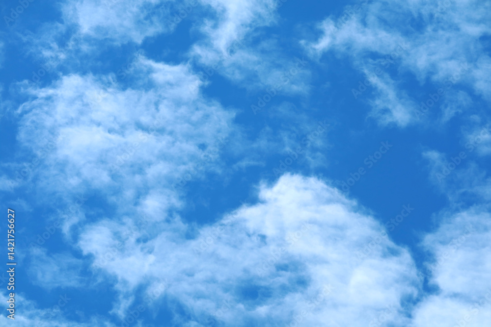 Bright Blue Sky with Soft White Clouds for Background and Design Bright Blue Sky with Soft White Clouds for Background and Design