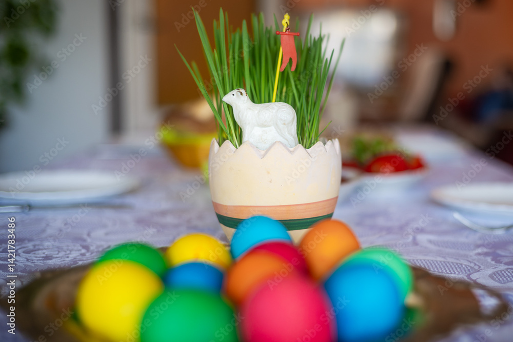 Easter decoration with a lamb figurine, eggs and other dishes on the table