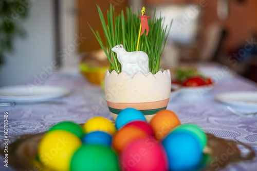 Obraz na płótnie Easter decoration with a lamb figurine, eggs and other dishes on the table w salonie