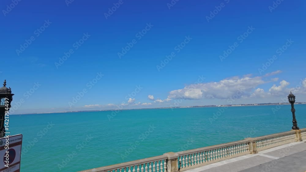 Panoramic view of the Bay of Cadiz with turquoise water and blue sky, from the seafront of Cadiz, Andalusia, Spain Panoramic view of the Bay of Cadiz with turquoise water and blue sky, from the seafront of Cadiz, Andalusia, Spain