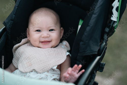 Asian mother lovingly holds her smiling baby, capturing heartfelt family moment the deep bond, emotional connection, tenderness, nurturing care, warmth happiness parenthood, childhood relationships