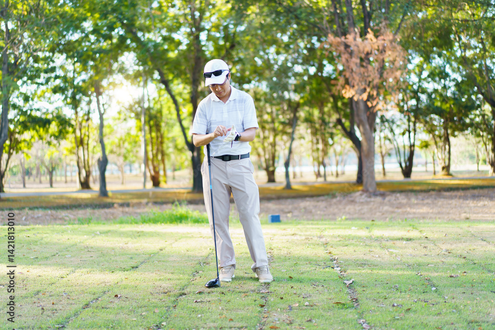 Fototapeta premium An Asian amateur golfer is enjoy playing golf in golf country club.