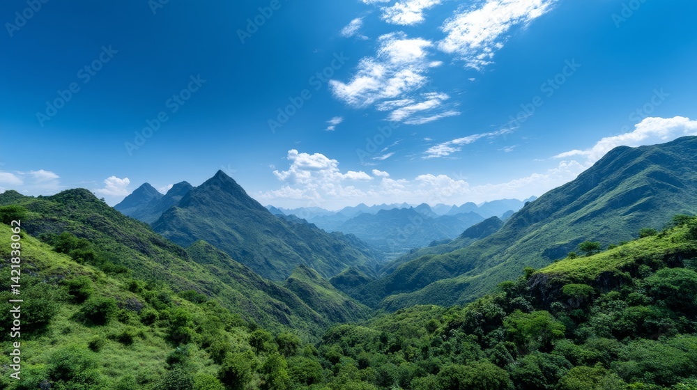 Fototapeta premium Majestic Mountain Valley Landscape - Stunning panoramic view of a lush green mountain valley under a vibrant blue sky with fluffy white clouds