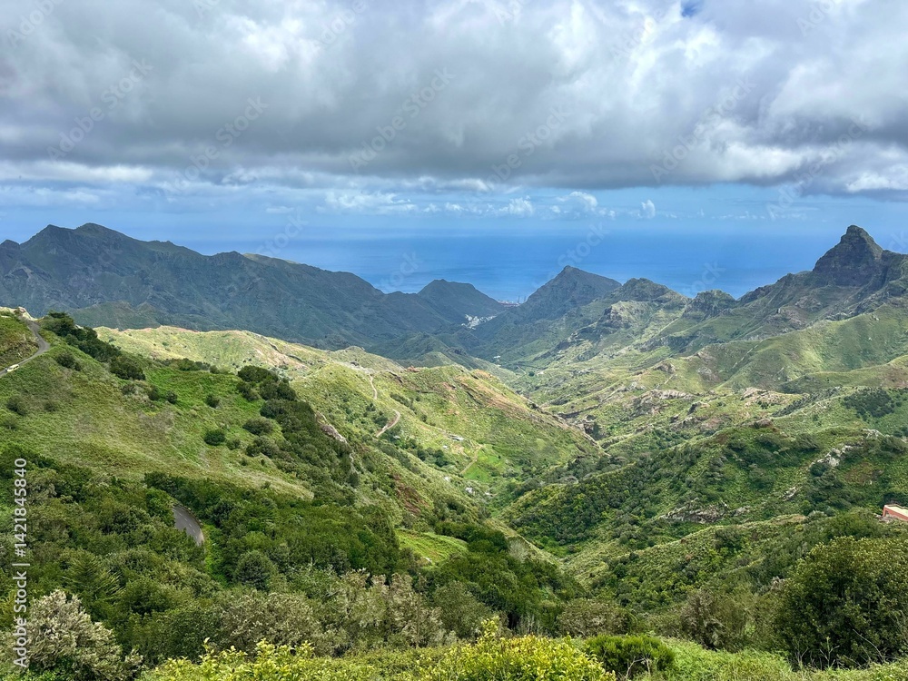 Obraz premium Panoramic view of green Anaga mountains on blue ocean and sky background, sunny day in the North of Tenerife, Canary Islands, Spain 