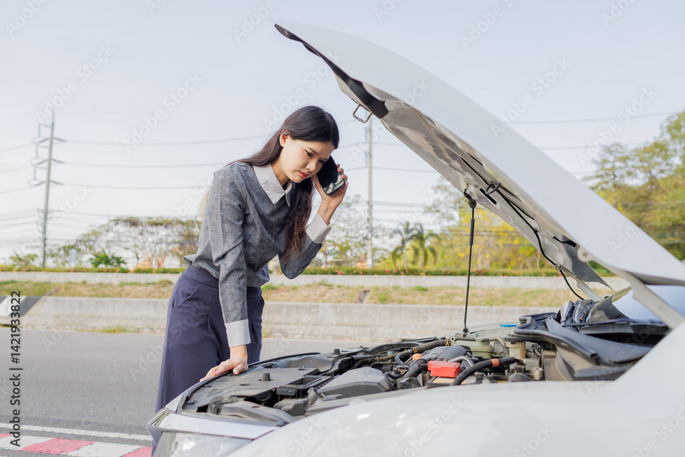 Naklejka premium A young woman feels anxious as her car breaks down and stops by the roadside. She tries to call a relative for help