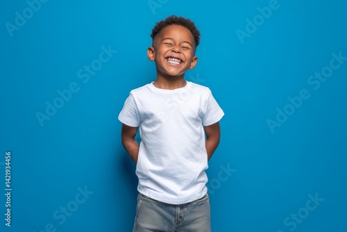 Wallpaper Mural Happy smilling boy wearing bella canvas white shirt mockup, at blue background. Design tshirt template, print presentation mock-up Torontodigital.ca