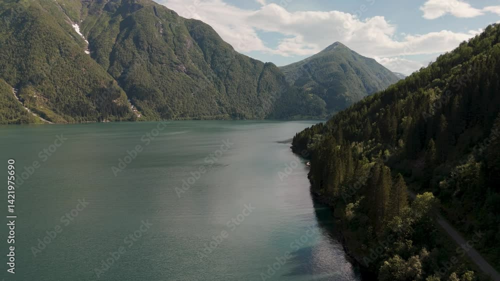 Breathtaking views of a tranquil fjord in Sognefjord Norway, surrounded by lush green mountains and a clear blue sky. The calm waters reflect the stunning natural beauty, inviting adventure and peace Breathtaking views of a tranquil fjord in Sognefjord Norway, surrounded by lush green mountains and a clear blue sky. The calm waters reflect the stunning natural beauty, inviting adventure and peace