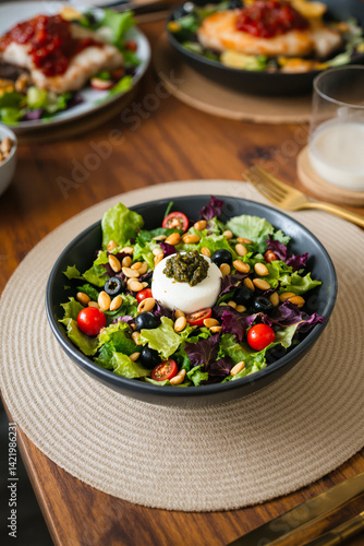 vibrant salad with creamy burrata cheese and pesto dressing