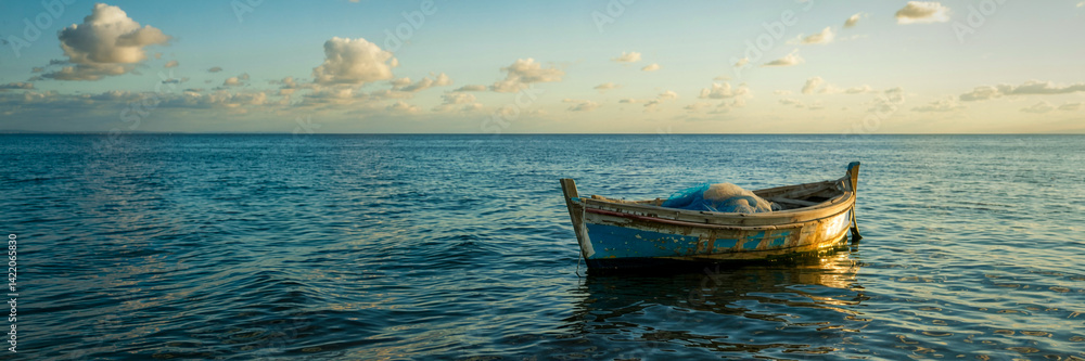 Serene Seascape Featuring Small Fishing Boat Floating On Calm Ocean Water Serene Seascape Featuring Small Fishing Boat Floating On Calm Ocean Water