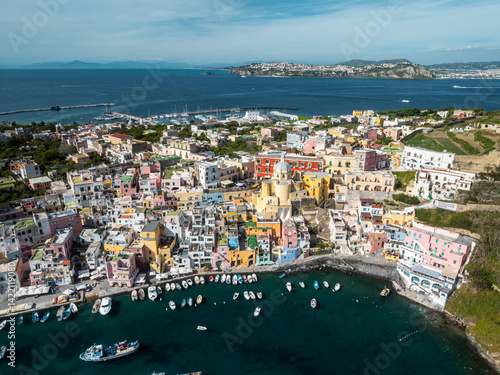 A top-down view of the vibrant rooftops and narrow alleys of Terra Murata, the oldest settlement on Procida island