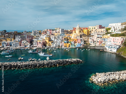 A top-down view of the vibrant rooftops and narrow alleys of Terra Murata, the oldest settlement on Procida island