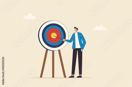 Specific goal, clarify objective or target, focus or concentrate on purpose to win business mission, perfection or aiming at target concept, businessman pointing at center of bullseye archery target.