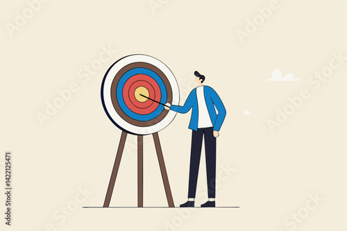 Specific goal, clarify objective or target, focus or concentrate on purpose to win business mission, perfection or aiming at target concept, businessman pointing at center of bullseye archery target.