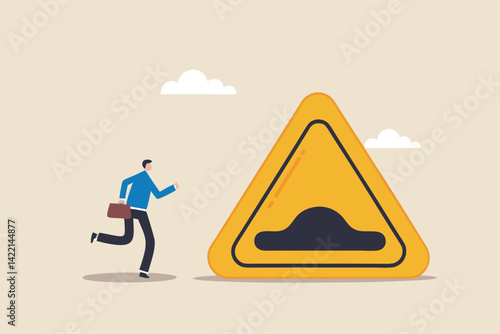 Business slow down due to obstacles, difficulty or speed limit, beware of crisis ahead or recession, economic depression concept, businessman running with arrow to find speed bump slow down sign.
