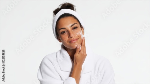 Woman applying skincare on her face.