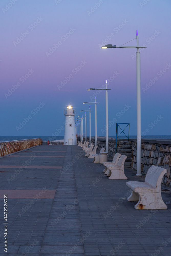 Obraz premium blue hour with the lighthouse on the pier of the port of Porto Maurizio, Imperia, Liguria, Italy, Europe