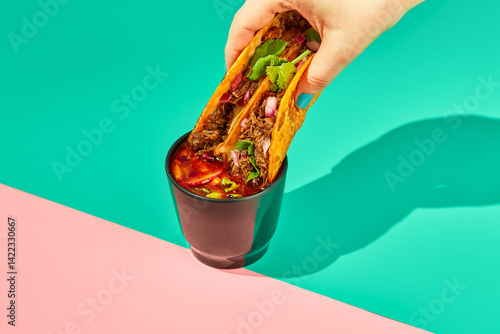 Traditional mexican birria ramen consomme soup and tacos with braised beef. Dip tacos in broth.