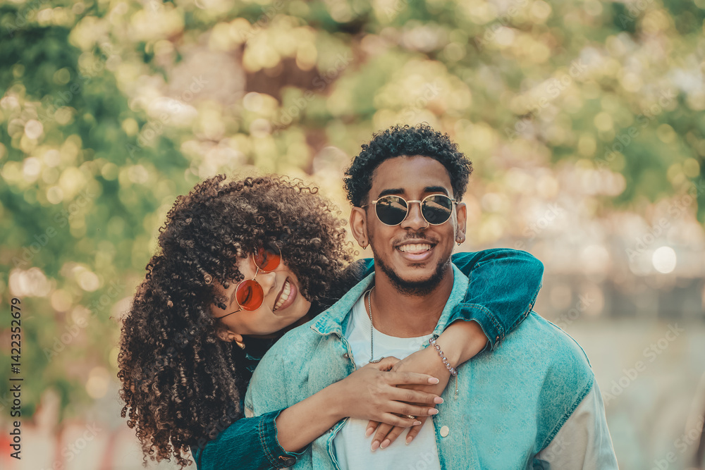 romantic latin couple hugging happily outdoors