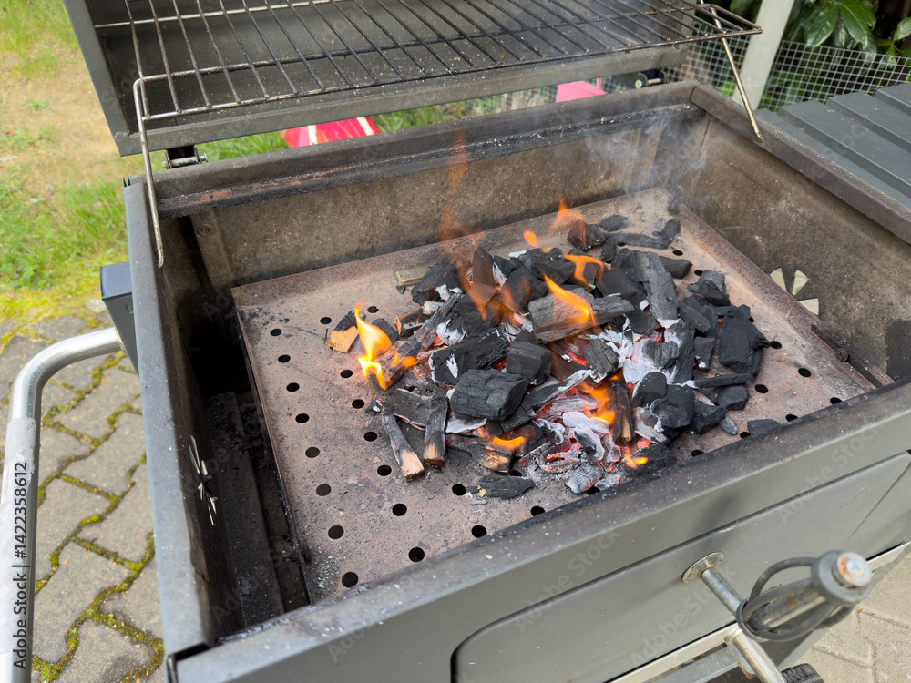 coal burning in a fireplace grill in the garden