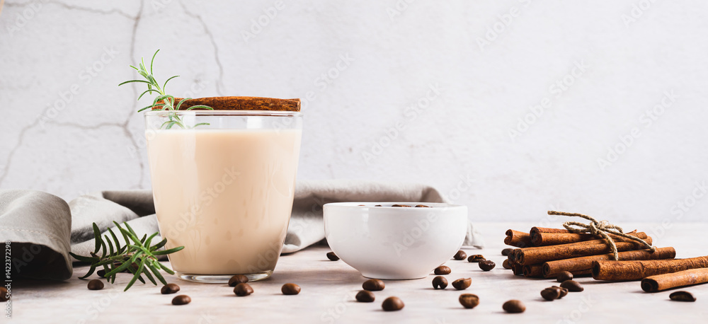 Aromatic coffee with rosemary and cinnamon in a glass on the table web banner