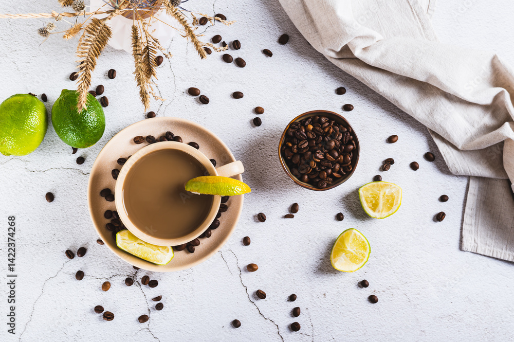 Cold coffee with lime wedges in a cup on the table top view
