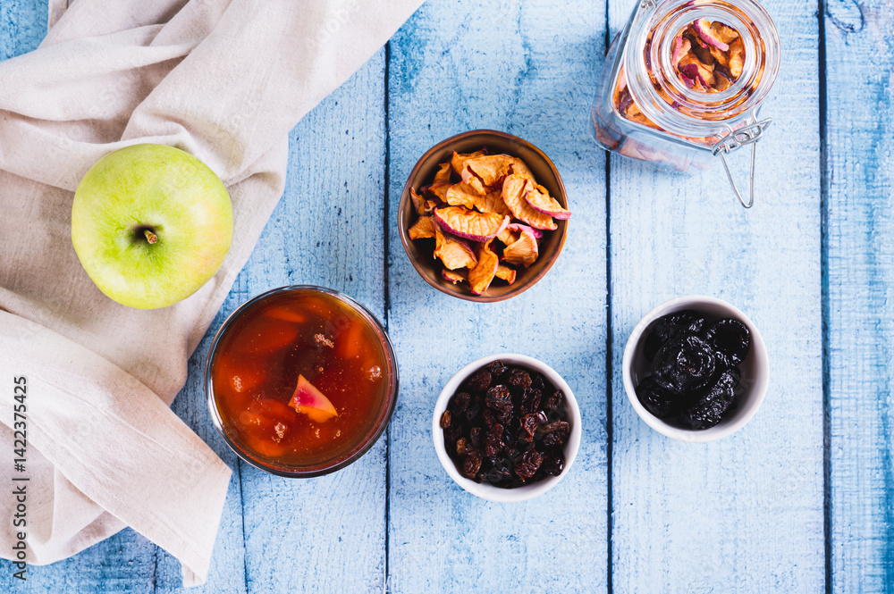 Traditional drink made from prunes, raisins and apples uzvar in a glass on the table top view