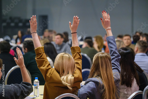 Wallpaper Mural Attendees in a seminar actively participate by raising hands to engage in discussions. Torontodigital.ca