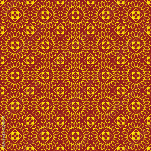 Striking tribal pattern in glowing gold tones, layered with ikat floral design against a red garnet