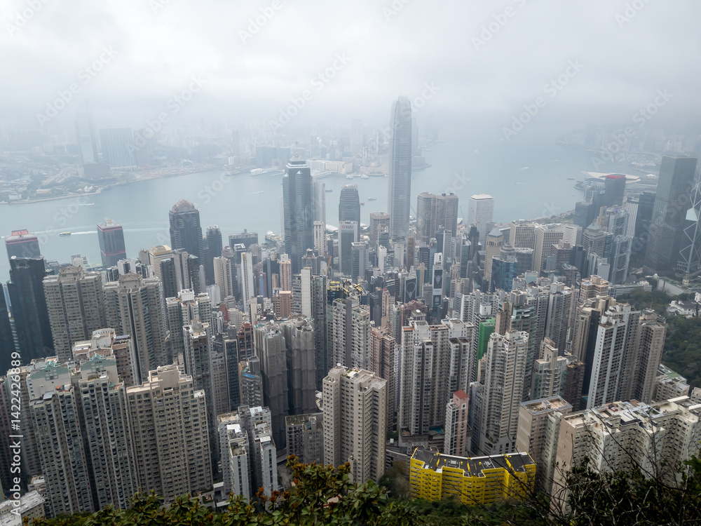 Fototapeta premium Hong Kong. China- 03.01.2025. A high angle view of the Central city skyline covered in heavy mist from the Lugard Road Lookout on the Peak.