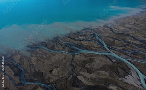 Aerial panorama view of braided river arms streams delta, glacial pristine clear azure blue Southern Alps mountain water at Lake Pukaki, New Zealand