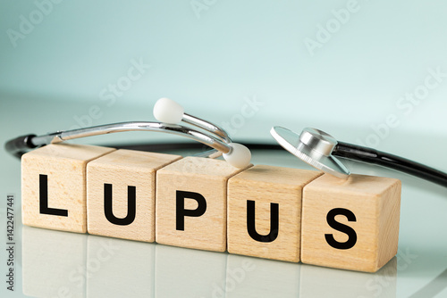 Lupus, Systemic Lupus Erythematosus. autoimmune disease. Immune system disorders. Medical stethoscope and word written on wooden blocks, pastel blue background, copy space