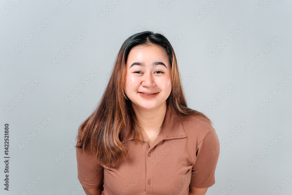 Portrait of a young Asian woman with a soft smile and calm facial expression, conveying warmth and friendliness. Ideal for concepts of kindness, sincerity, and approachability. Portrait of a young Asian woman with a soft smile and calm facial expression, conveying warmth and friendliness. Ideal for concepts of kindness, sincerity, and approachability.