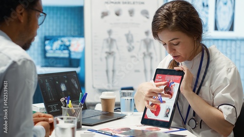 Photos Woman specialist explaining heart function and condition on test results, doctor patient interaction in a cabinet