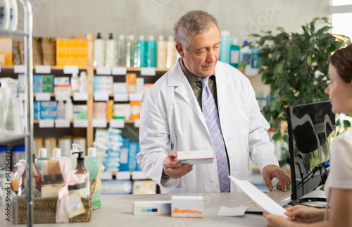 Wallpaper Mural Elderly man pharmacist giving prescription pills to young woman buyer in pharmacy Torontodigital.ca