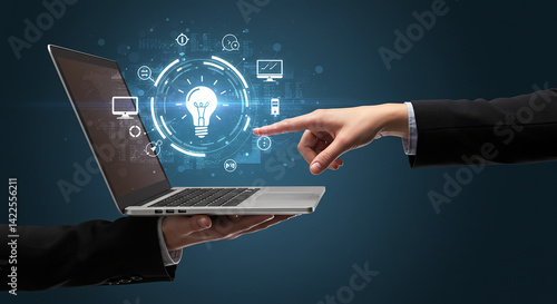 A hand holding a laptop with a lightbulb icon and another hand pointing at the screen interface