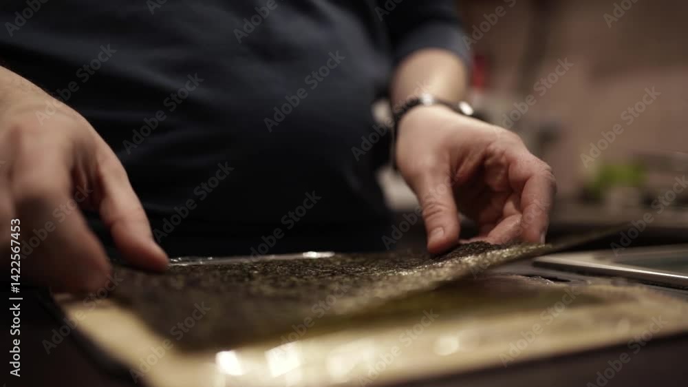 Chef Slicing Salmon and Preparing Sushi Rolls with Cheese and Cucumber Chef Slicing Salmon and Preparing Sushi Rolls with Cheese and Cucumber