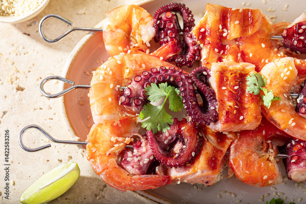 Tasty roasted skewer with octopus and salmon.