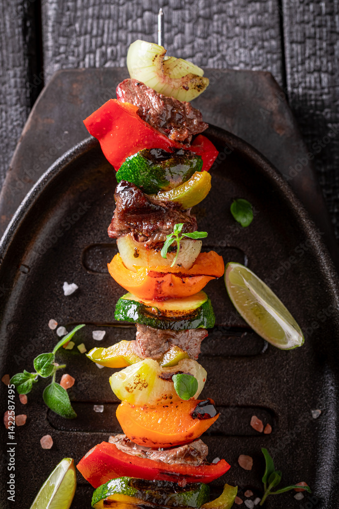 Hot grilled skewer made of beef and vegetables.