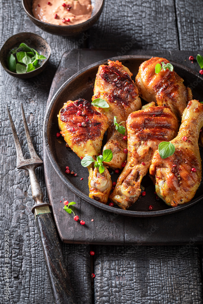 Spicy grilled chicken leg as summer delicacy in sunny day.