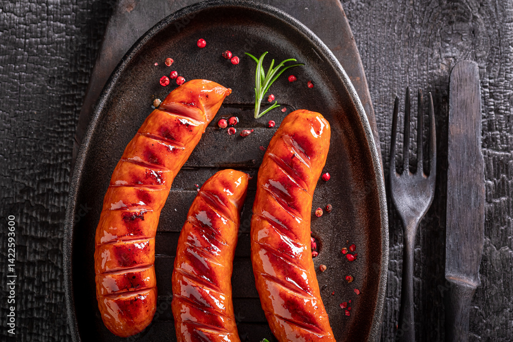 Tasty grilled sausage served with lime and rosemary.