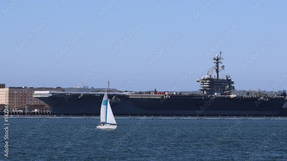 Sailboat Passing An Aircraft Carrier Sailboat Passing An Aircraft Carrier